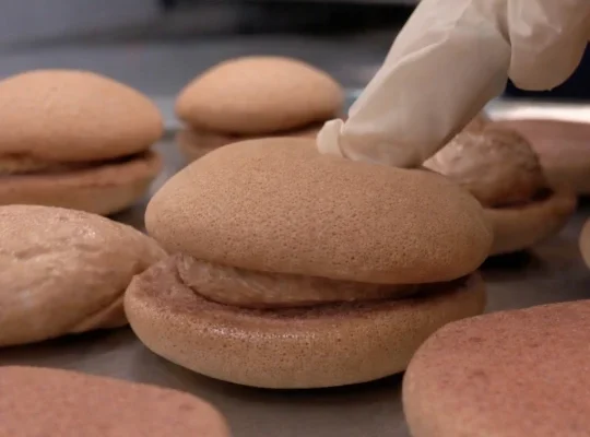 Filling chocolate pancakes with cream